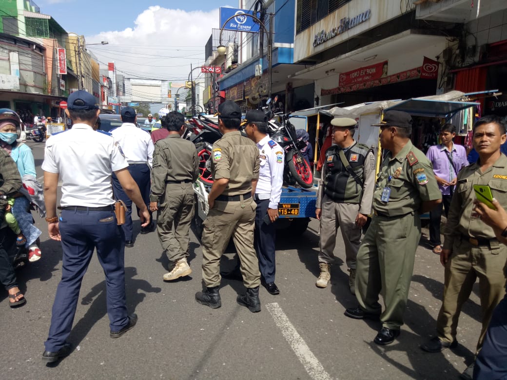 Petugas gabungan melakukan razia di kawasan tertib lalu lintas, Jalan Ahmad Yani, Kecamatan Garut Kota, Sabtu (23/2/2019). Belasan kendaraan diangkut petugas karena memarkir kendaraannya di lokasi yang dilarang. Foto: dara.co.id/Benny