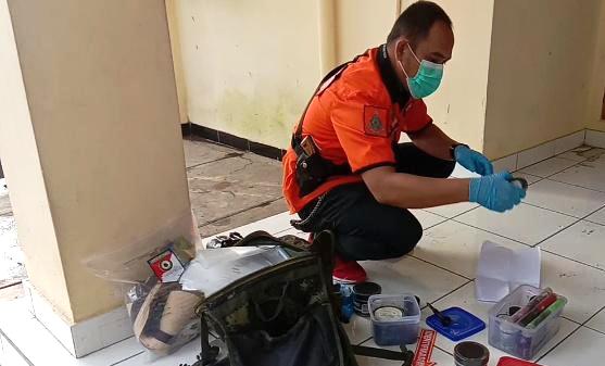 Anggota Tim Inafis Polres Bandung mengidentifikasi sidik jari kawanan maling. Foto:  Ist