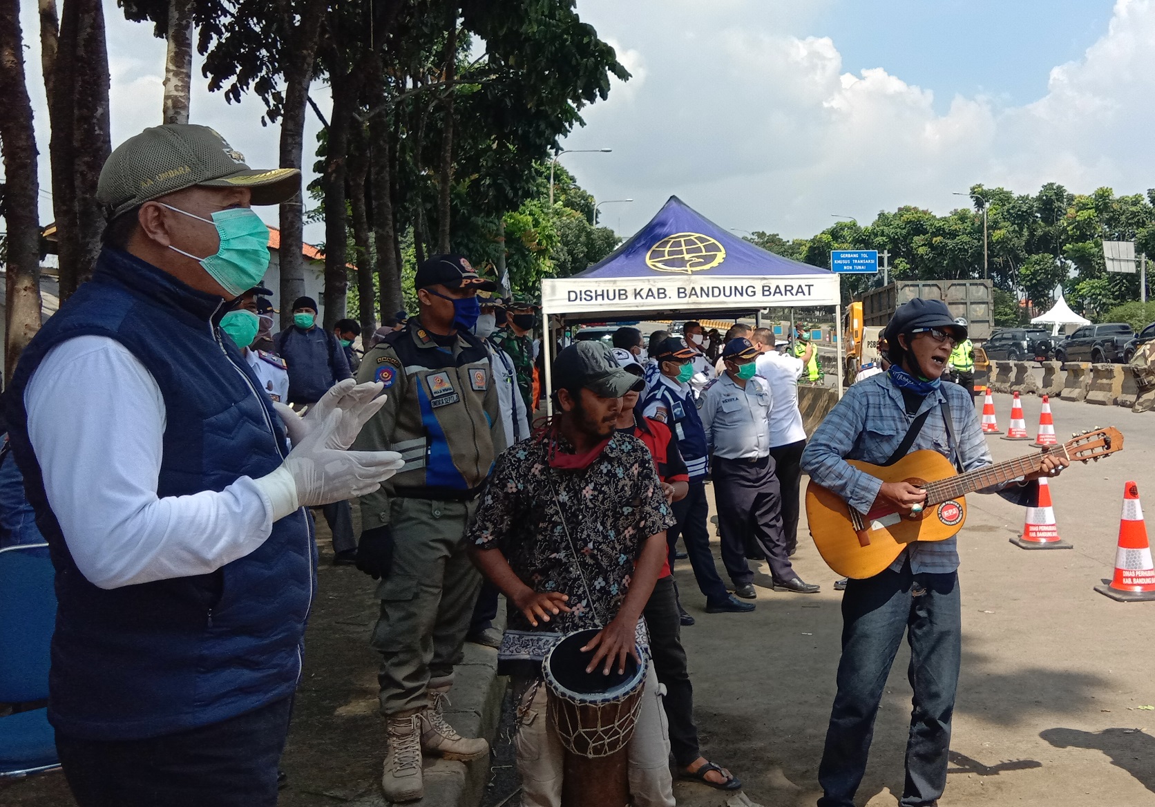 Bupati Bandung Barat, Aa Umbara Sutisna dihibur oleh sejumlah pengamen jalanan di sela meninjau titik pemeriksaan PSBB di GT Padalarang, KBB, Rabu (22/4/2020). (Foto: Heni Suhaeni/dara.co.id)