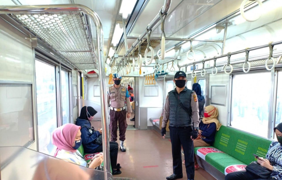 Dua orang personel Polda Jawa Barat melakukan pengawasan di gerbong KRL Bogor, Jawa Barat, Kamis (28/5/2020). (Foto: Humas Polda Jabar)