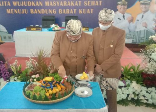 Bupati Bandung Barat, Aa Umbara Sutisna (kiri) didampingi Wakil Bupati Bandung Barat, Hengki Kurniawan saat memotong tumpen pada HUT KBB ke-13 di Aula Utama Kantor Pemkab Bandung Barat, Ngamprah, Jumat (19/6/2020).