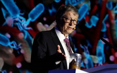 Microsoft founder Bill Gates points at a jar containing human faeces during his speech at the Reinvented Toilet Expo showcasing sewerless sanitation technology in Beijing, China November 6, 2018. REUTERS/Thomas Peter