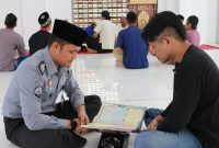 
Pembina kerohanian Islam Lapas Banceuy Rifqi Buhori sedang membimbing warga binaan pembaca Al Quran, Selasa (5/9/2023). (Foto: Ist)
