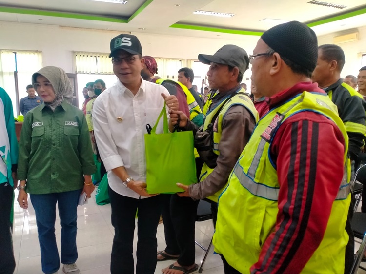 
Bupati Bandung Dadang Supriatna menyerahkan bantuan bahan pangan kepada ojeg pangkalan yang ada di tiga kecamatan di Kabupaten Bandung, Selasa (21/11/203). (Foto: diskominfo) 
